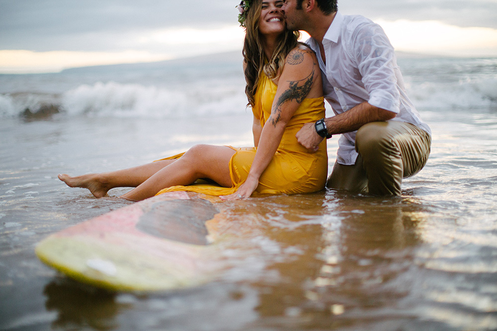 surfboard couple during engagement photos in wailea