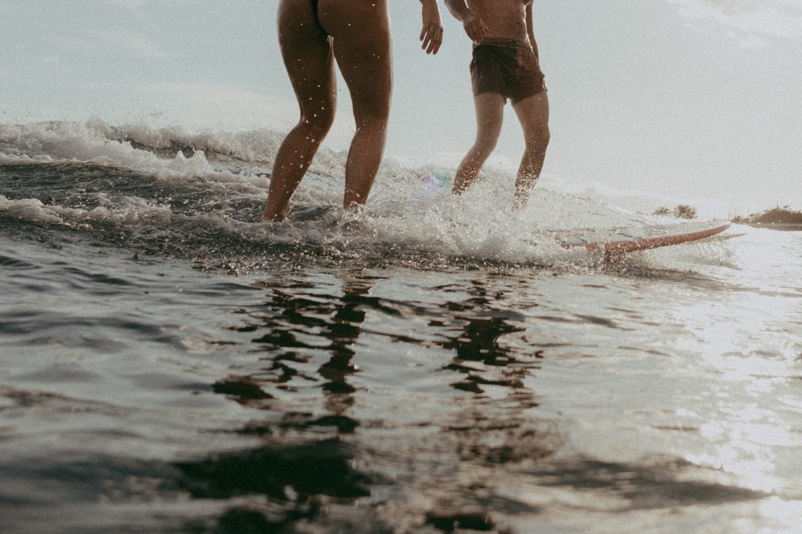 underwater couples photos on Maui on surfboards
